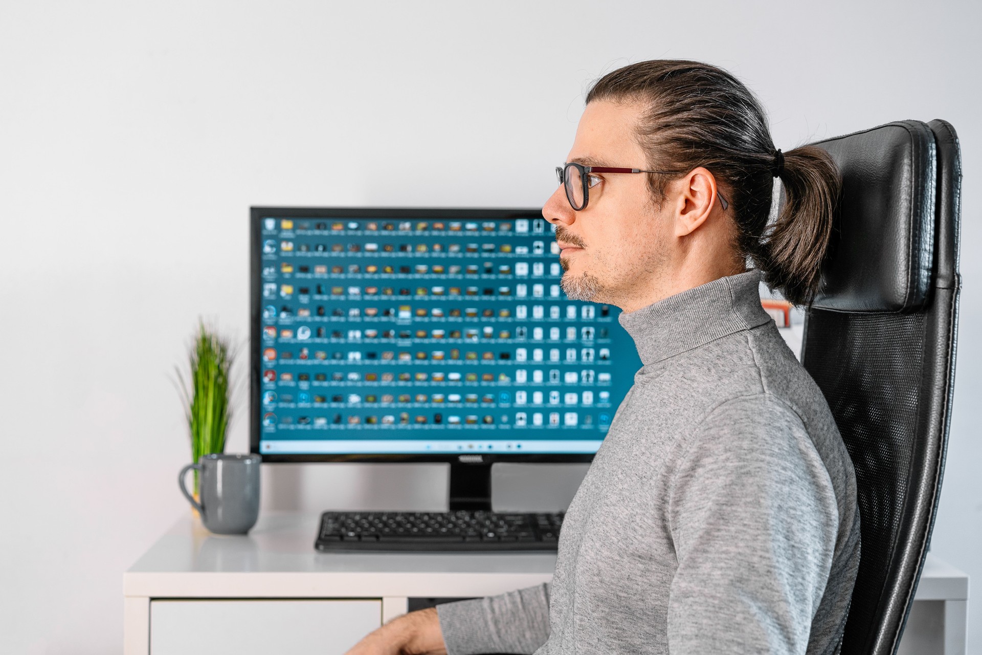 Mature Man On Chair By Personal Computer At Home